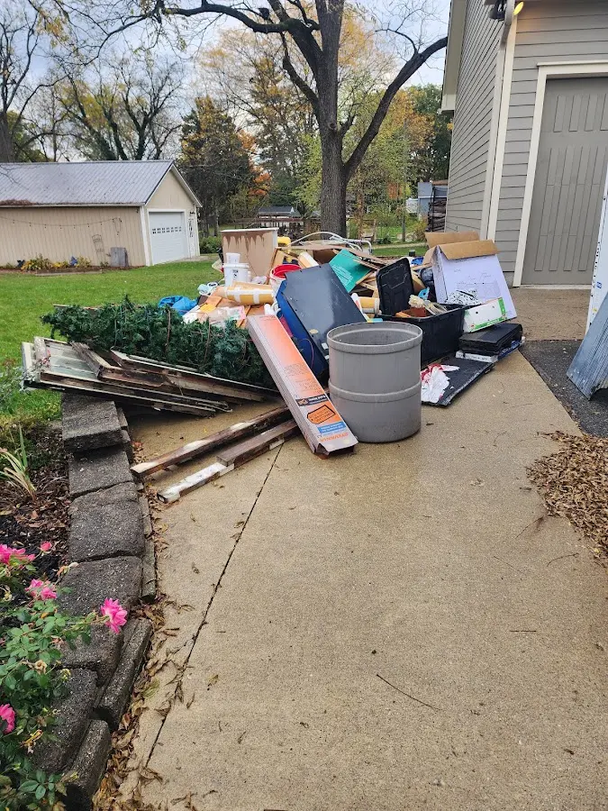 Dumpster being loaded with debris for Roofing Dumpster Rental in Rush City